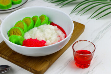 Es Pisang Ijo or Green banana ice, one of Indonesian popular dessert from east Sulawesi, Makassar. Es Pisang ijo made from banana coated with green flour dough, serve with red syrup.
