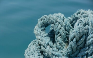 Blue rope for the boat by the sea nautical background