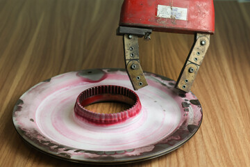 Close up hand checking piston with Magnetic particle testing (MPT), is a non destructive examination (NDE) technique used to detect surface and slightly subsurface flaws in most ferromagnetic material