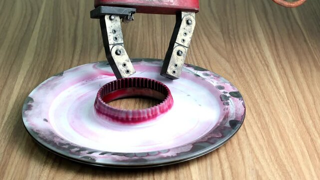 Close up hand checking piston with Magnetic particle testing (MPT), is a non destructive examination (NDE) technique used to detect surface and slightly subsurface flaws in most ferromagnetic material