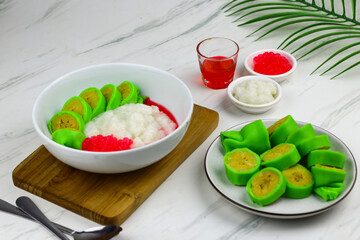 Es Pisang Ijo or Green banana ice, one of Indonesian popular dessert from east Sulawesi, Makassar. Es Pisang ijo made from banana coated with green flour dough, serve with red syrup.