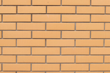 Brick wall texture, background. Orange brick wall background for exterior design. Construction concept, outdoor buildings, garage or house. Wall with classic checkerboard pattern and visible joints