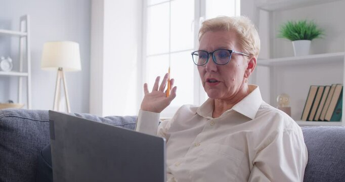 Middle aged woman at home, pleasant 50s elderly business woman on video conference calling on laptop computer, talking by webcam, learn or teach in online chat, distance webinar online teaching