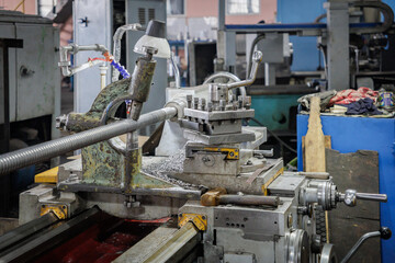 The lathe on which the metal part is made