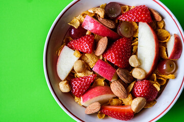 Bowl Of Corn Flakes Breakfast Cereal With Fresh Fruit And Mixed Nuts