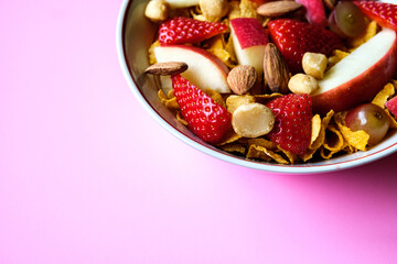 Bowl Of Corn Flakes Breakfast Cereal With Fresh Fruit And Mixed Nuts