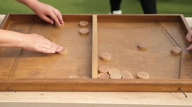 Elastic board game where speed, accuracy and strategic thinking become the keys to victory. Shoot pucks through small gates in the middle of the playing field with the help of a rubber band. 