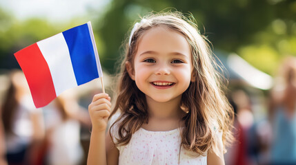 Young girl joyfully waving a French flag during a summer festival celebration in a park