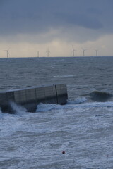 Some strong waves are hitting the jetty on a stormy day. Batz-sur-Mer, France - November 2, 2023. 