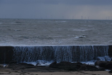 Some strong waves are hitting the jetty on a stormy day. Batz-sur-Mer, France - November 2, 2023. 