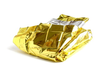 On a white isolated background lies foil for keeping warm in a critical situation.