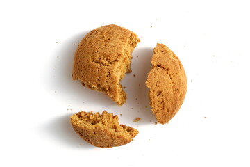 Pieces of fresh oatmeal cookies lie on a white background.	