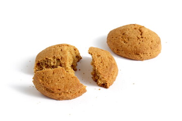 Pieces of fresh oatmeal cookies lie on a white background.	