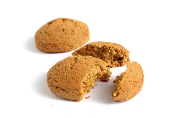 Pieces of fresh oatmeal cookies lie on a white background.