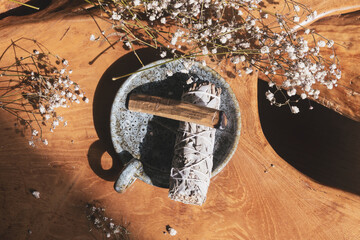 Sage Smudge Stick And Palo Santo On Wooden Table
