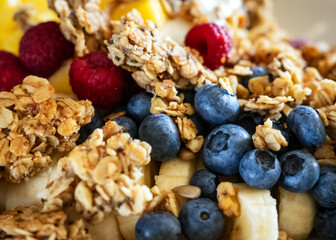 Healthy Breakfast Bowl with Granola, Blueberries, Bananas, and Raspberries – Close-Up