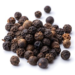 Freshly harvested whole black peppercorns spilled on a clean white surface for culinary preparation