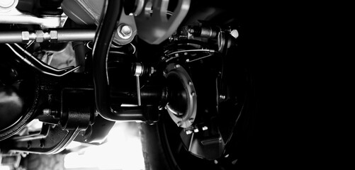 Car suspension part. Close up of a rear car suspension and exhaust system. such as coil springs...