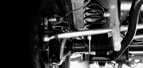 Car suspension part. Close up of a rear car suspension and exhaust system. such as coil springs...