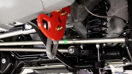Car suspension part. Close up of a rear car suspension and exhaust system. such as coil springs...