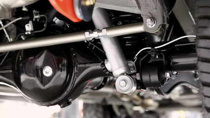 Car suspension part. Close up of a rear car suspension and exhaust system. such as coil springs...