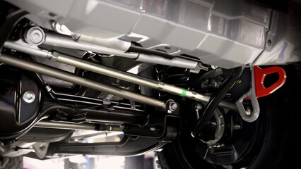 Car suspension part. Close up of a rear car suspension and exhaust system. such as coil springs...