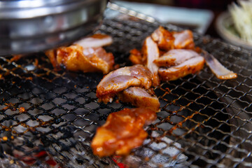 roasting spicy marinated-chicken meat on the charcoal grill