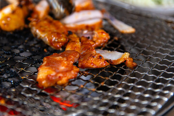 roasting spicy marinated-chicken meat on the charcoal grill