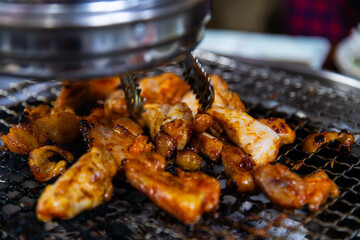 roasting spicy marinated-chicken meat on the charcoal grill