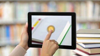 A hand interacts with a tablet displaying a book and an icon, set against a blurred background of stacked books.