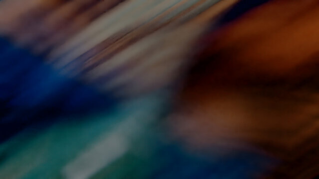 Abstract dark textured background with multi-colored blurred streaks, ideal for artistic and expressive digital concepts