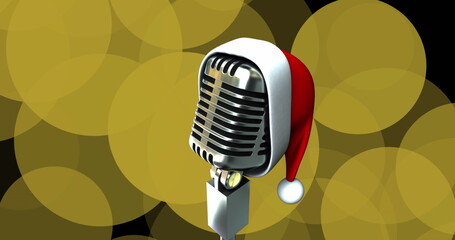 Standing retro microphone wearing red and white Santa hat on studio stage, with golden bokeh lights