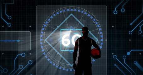 Basketball player silhouette in jersey holding basketball in studio with digital display showing 60