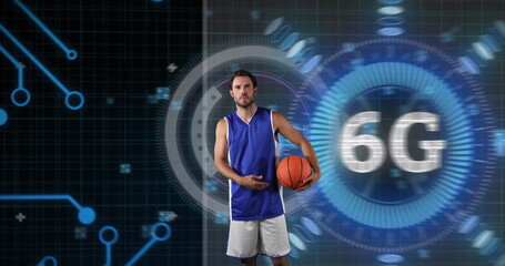 Posing adult male athlete in jersey holding basketball in tech studio, with holographic 6G overlay