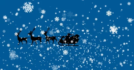 Fotobehang Gliding silhouette Santa Claus riding sleigh across winter sky, with four reindeer and snowflakes © vectorfusionart