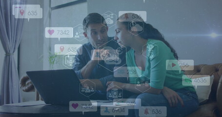 Couple reviewing metrics on laptop in living room, with social media analytics icon overlays