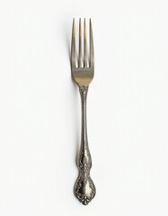 Isolated antique silver fork with engraved handle on white background

