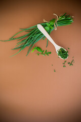 Preparing dried onions for winter in home kitchen on brown background