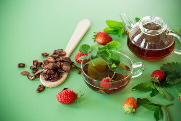 Delicious strawberry infusion in a teapot, top view