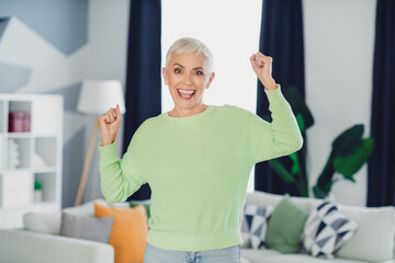 Happy woman enjoying leisure time indoors with happiness and confidence in a casual and colorful...