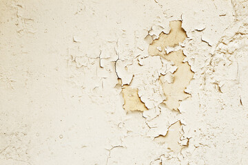 Old stone wall with cracked light color paint background
