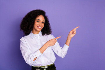 Confident businesswoman gesturing with hands, promoting ideas against a purple background, inspiring success and creativity