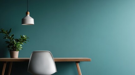 A clean and minimalist workspace featuring a solitary plant and a wooden desk, embodying serenity and focus suited for creativity and productivity in a modern environment.