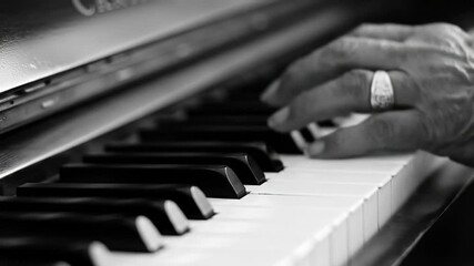 Hand playing piano keys