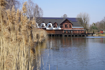 Fototapeta premium Przygodzice, Górecznik, Greater Poland; Reeds and a guesthouse by the lake; house on the lake