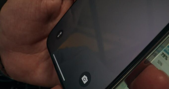A man hangs up after talking to his boss on a mobile phone. Close-up of the screen