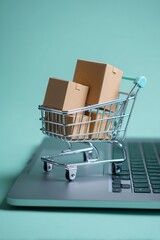 Creative Online Store Visual with Mini Cart and Delivery Boxes Arranged on Laptop Keyboard