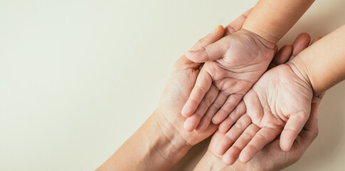 Family Day concept, Top view of parents and kid holding empty hands isolated. Signifying...