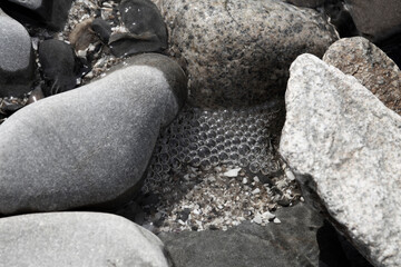 foaming water among stones, background