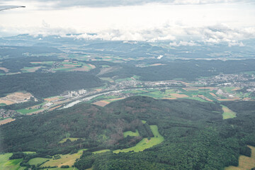 An aerial view showcasing a beautiful countryside landscape with lush greenery, a river, and...